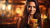 Photo 300 DPI: Girl with tiki cocktail. Blurred beach bar on