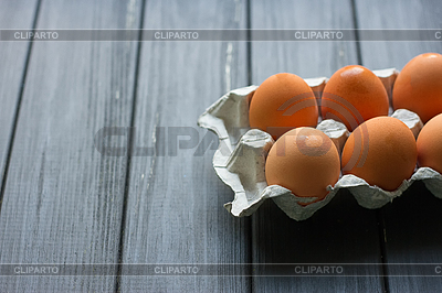 Cardboard egg box on black wooden background | High resolution stock photo |ID 6369700