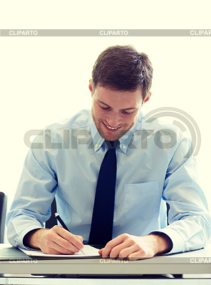 Smiling businessman signing papers in office | High resolution stock photo |ID 5371782
