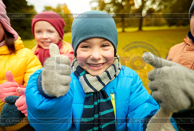 Happy children showing thumbs up in autumn park | High resolution stock photo |ID 5452829