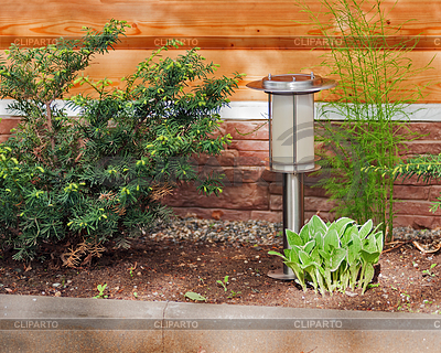 Solar-powered lamp on garden background | High resolution stock photo |ID 4521005